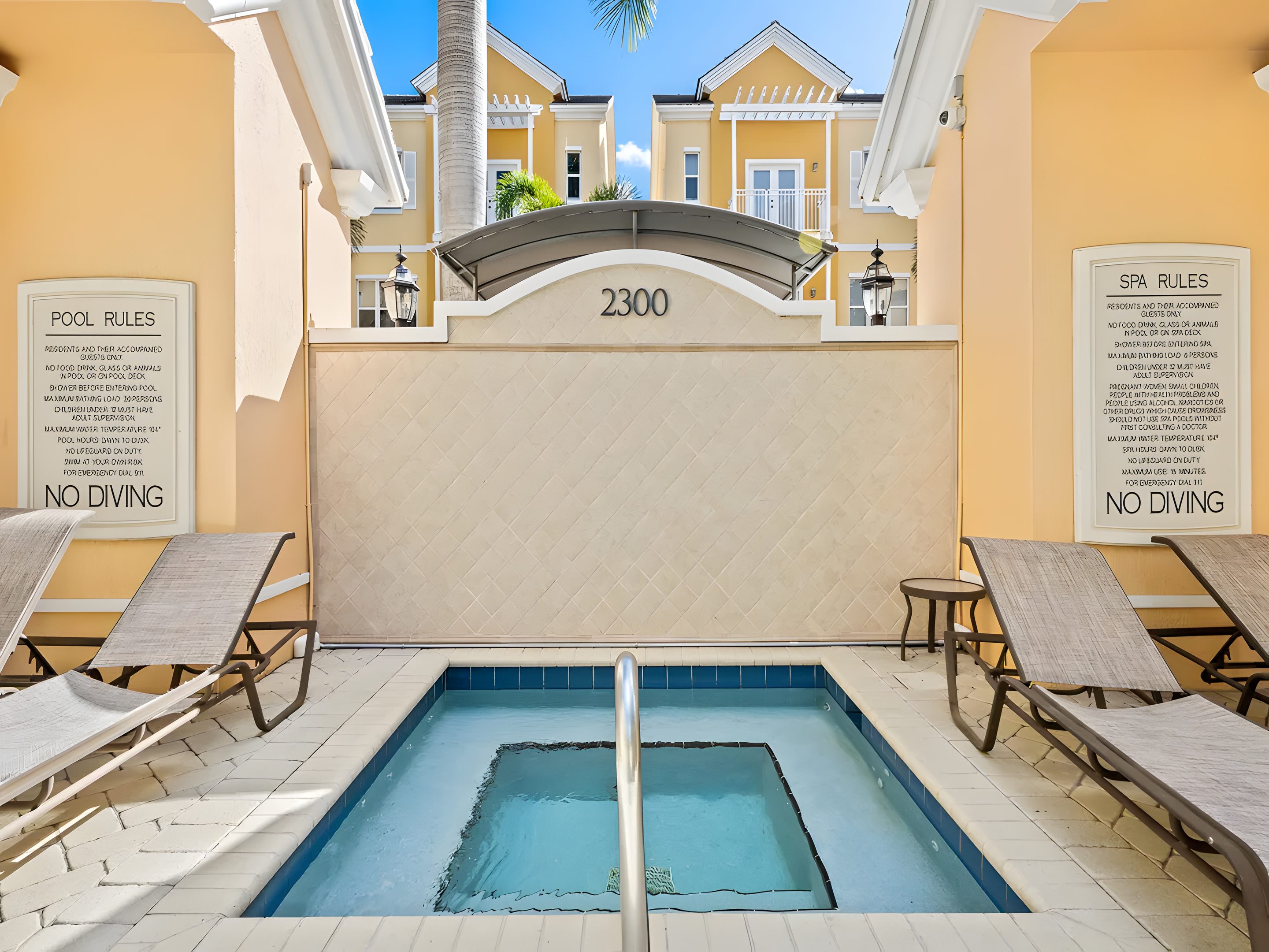 The spa beneath the 2300 arch, with the posted pool and spa rules either side.